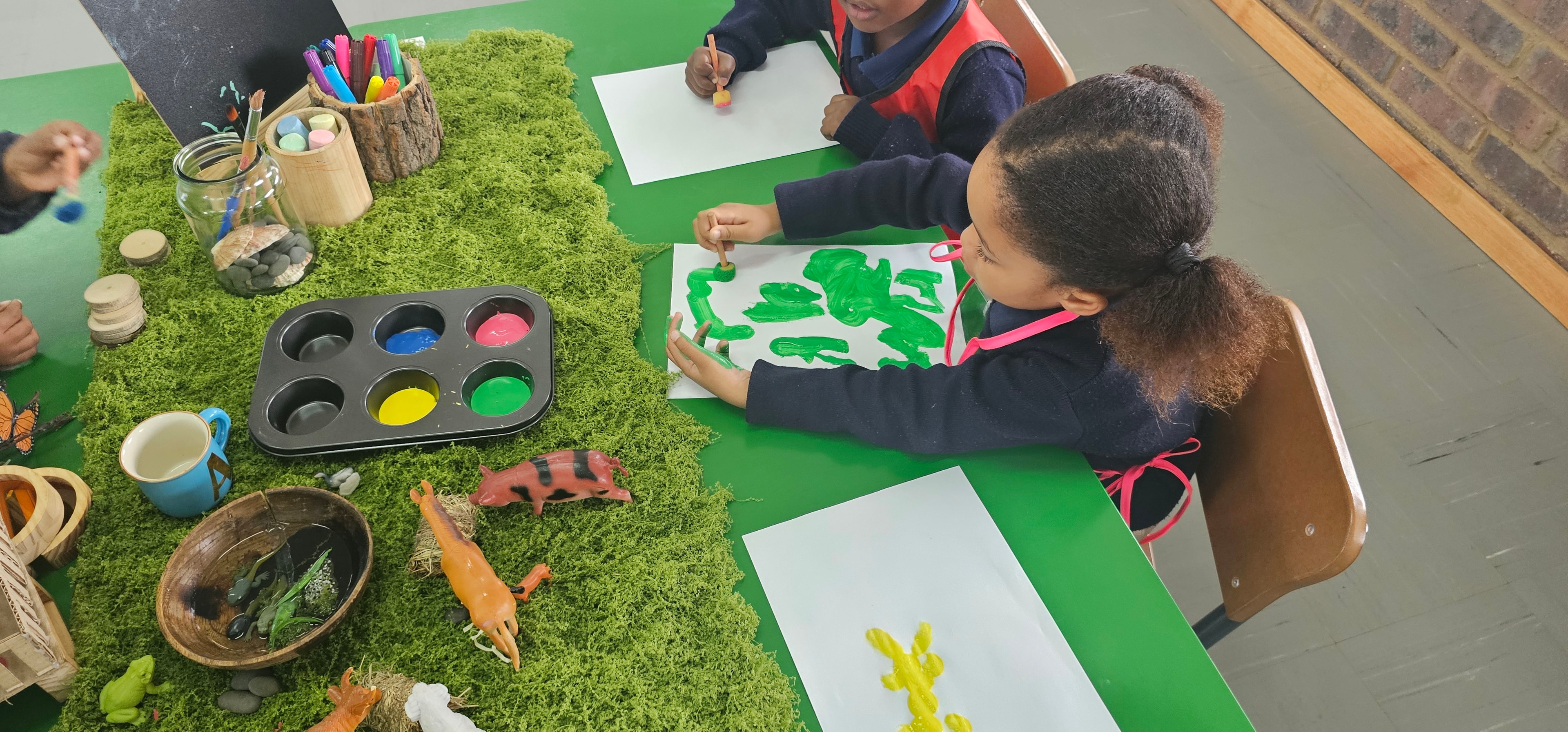 Learners painting during a classroom activity at AfriDawn College